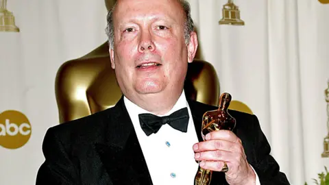 Alamy Julian Fellowes holding his Oscar