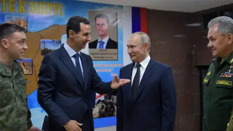 EPA Syrian President Bashar al-Assad talks to Russian President Vladimir Putin in Damascus, Syria (7 January 2020)