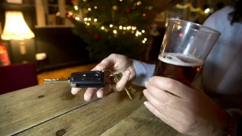 PA Media Person holding beer and car keys