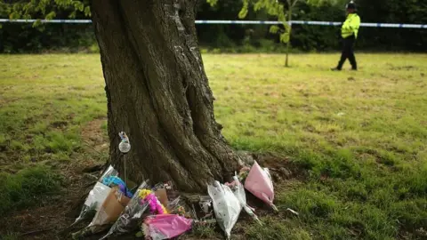 Getty Images Flowers around a tree