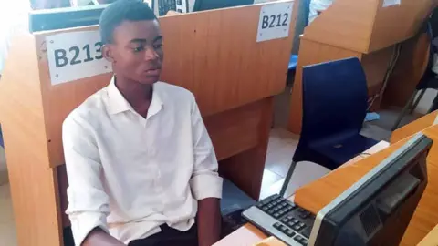 Chimezie Aneke Christian Asogwa at a computer during his monthly assessment at nearby Institute of Management and Technology (IMT) in Enugu, Nigeria