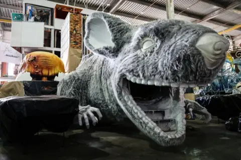 BBC A figure of a rat is prepared for a float