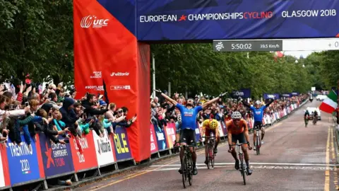 Getty Images Matteo Trentin of Italy celebrates as he crosses the line and wins gold in the men's road race