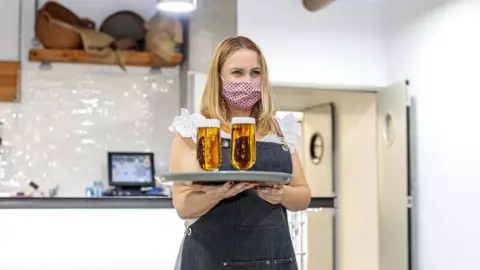 Getty Images Waitress wearing face mask