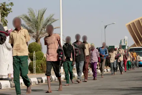 Reuters Freed Nigerian schoolboys walk after they were rescued by security forces in Katsina, Nigeria, December 18, 2020. REUTERS/Afolabi Sotunde