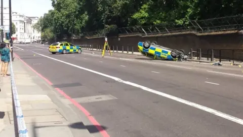 Met Police car overturns in London moped chase