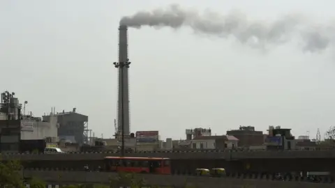 Getty Images Smoke rises from the Badarpur Thermal Power Station in New Delhi on June 5, 2017, on the United Nation's World Environment Day.