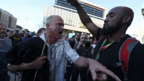 Getty Images A fan trying to enter the arena argues with a Black Lives Matter demonstrator