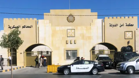 People walk outside the State Security Court (SSC) in Amman, Jordan (21 June 2021)