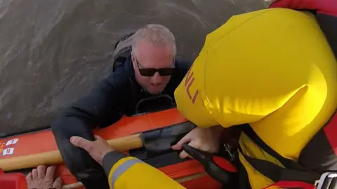 RNLI Mr Burton is pulled to safety