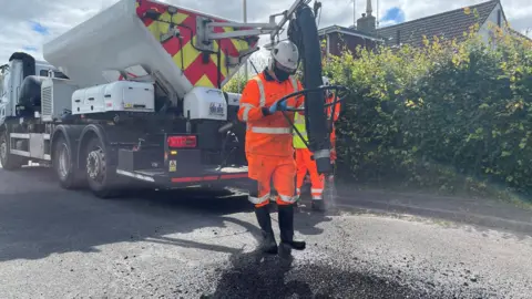 Gloucestershire County Council Truck with a hose on the back, which fires first air and then bitumen into a pothole.