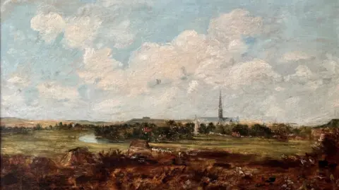 An oil painting showing blue sky with clouds and a cathedral and spire in the distance. Trees, fields and a river bend are painted in front of the cathedral.