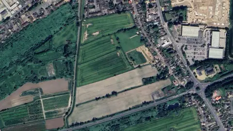 Google An aerial view of land near a number of houses, that is earmarked for development.