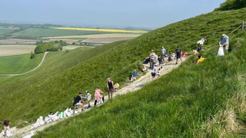 Volunteers re-chalking the white horse