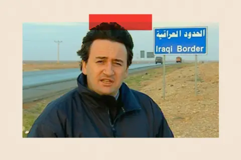 Fergal Keane in front of a sign for the Iraqi Border.