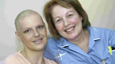 BBC An old photo of Natasha Hunt who had treatment for leukaemia and is alongside a nurse 