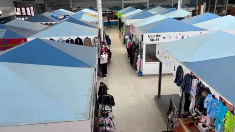 Simon Thake/BBC Looking down at the roofs of stalls in an old indoor market