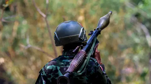 Reuters A soldier from the Karen National Liberation Army (KNLA) carries an RPG launcher at a Myanmar military base at Thingyan Nyi Naung village on the outskirts of Myawaddy, the Thailand-Myanmar border townr, April 15, 2024.