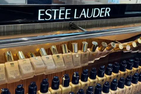 Getty Images A row of Estee Lauder cosmetics on a shop shelf, the brand name above them.