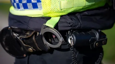 Getty Images A stock photo of a police officer's handcuffs.