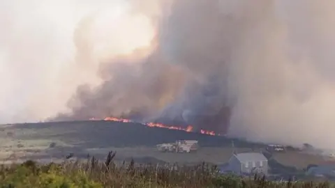 Flames and a column of smoke in Cornwall.