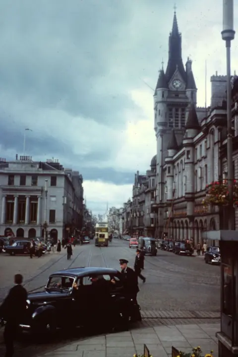 Ray Stokes Aberdeen's Union Street with old cars and buses from the 1950s.