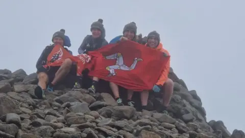 ISLE OF MAN FIRE AND RESCUE The team of fundraisers at the top of Slieve Donard