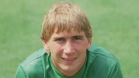 Getty Images Portsmouth goalkeeper Alan Knight, circa 1980. He has medium length blonde hair.