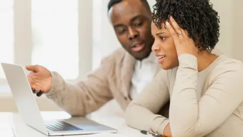 Getty Images Young couple looking at laptop