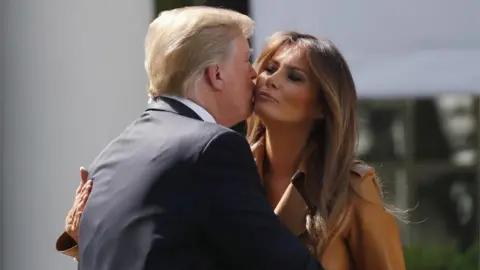 Reuters US President Donald Trump kisses First Lady Melania Trump after her speech