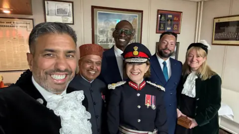 (L-R) Ammar Yusuf Mirza CBE,  Pundit Ji Krishan Attri MBE,  Rev Dr Peter Adegbie, Lord Lieutenant Lucy Winskell OBE, Imam Mohammed Rahman, Jo Curry MBE.