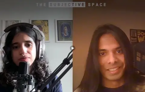 A young woman speaks into a microphone on the left hand side of the screen, while on the other side a long haired person is being interviewed