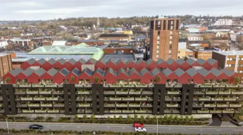 A high up view of a multi-storey car park - there are red buildings on top of it with a lot of greenery - the building is about six storeys high