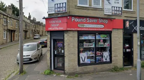 The exterior of a corner shop with a red sign reading "Pound Saver Shop".