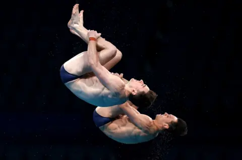 PA Media Tom Daley and Matty Lee diving in the men's synchronised 10m final at Tokyo 2020