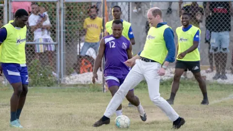 PA Media The Duke of Cambridge plays football with some young footballers in Jamaica