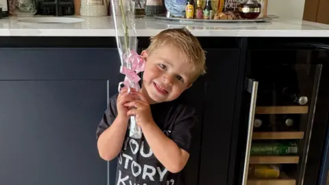 Kylie Minogue serenade leaves fan, 3, 'smiling ear to ear' 3 Glen Frost Three-year-old Reuben posing with a pink rose