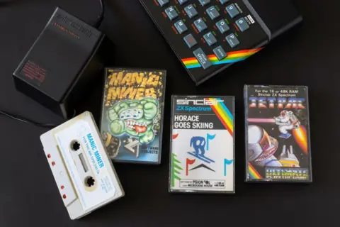 Alamy A ZX Spectrum home computer with three games on cassette and a power adaptor. The games are Manic Miner, Horace Goes Skiing and Jetpac