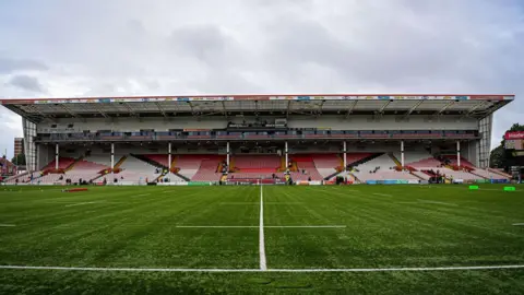 A general view across the pitch of a stand at Kingsholm stadium