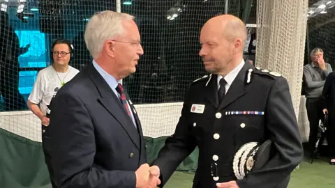 Photo of Gloucestershire's chief constable Rod Hansen shaking hands with Police and Crime Commissioner Chris Nelson