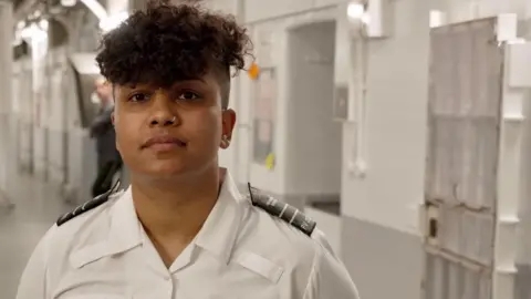 Prison serviceman  Shay Dhury is seen connected  a landing successful  1  of HMP Pentonville's wings - rows of cells wherever  prisoners are housed.