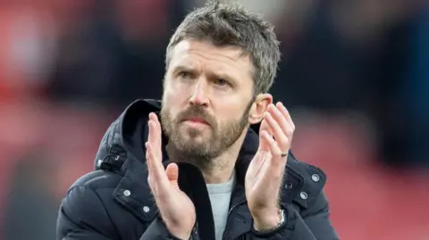 Michael Carrick applauds fans during his team in charge of Middlesbrough