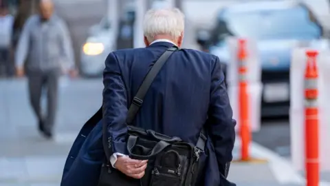 Getty Images A pedestrian in San Francisco, California, US, on Tuesday, May 7, 2024. US job openings fell in March to the lowest level in three years while quits and hiring slowed, indicating more softening in the labor market. 