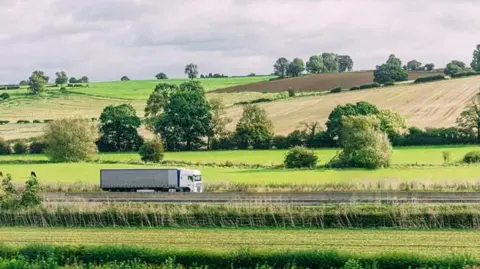 Getty Images Semi Truck/Articulated Lorry Driving south in Rural United Kingdom near Buckinghamshire, Bedfordshire, Northamptonshire, and Warwickshire
