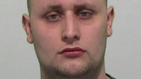 Northumbria Police Mugshot of a man with stubble and a large face