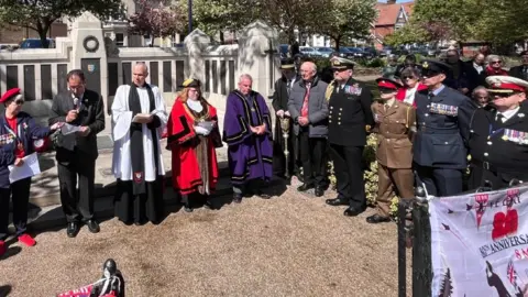 Martin Giles/BBC A gathering of people outside a park in Great Yarmouth, including the Mayor, for VE Day.