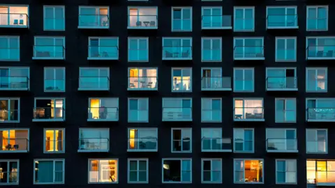 A block of flats at night in London