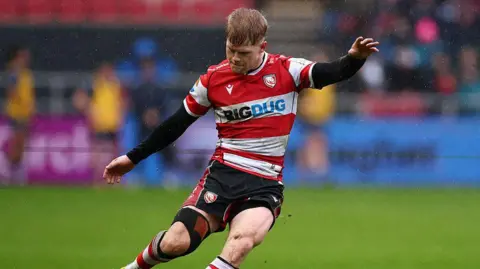 George Barton kicks the ball during a Prem Rugby Cup game for Gloucester this season