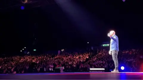 Callum Mills Ray Bradshaw performing comedy on stage