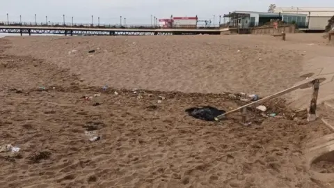 Submitted Skegness beach with the pier in the background, no one is on the beach but it is covered in litter